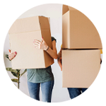 två personer bär flyttkartonger